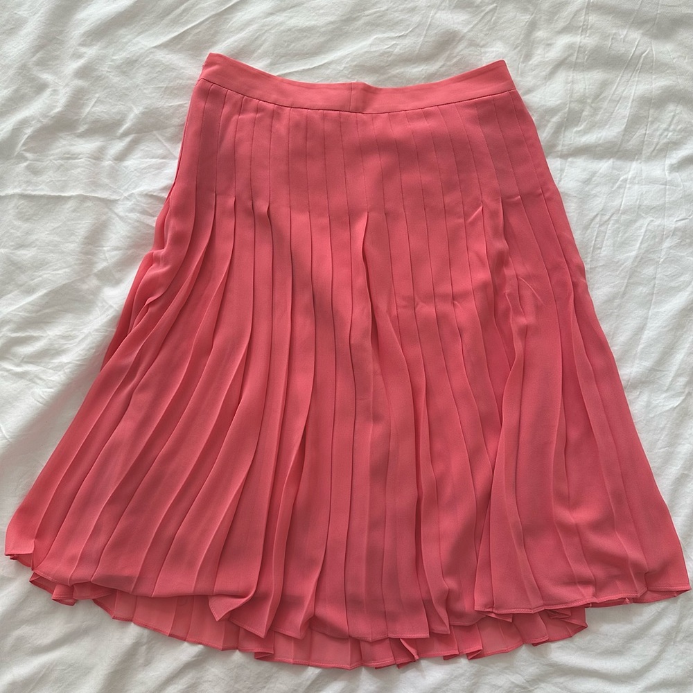 Pink pleated skirt.